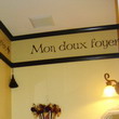 Mon Doux Foyer wall decal above the wall sconce and right before the wall partition to the ceiling.