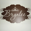 A wall decal with brown fonts and fancy ends - Brynlee