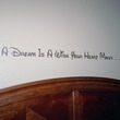 A Dream is a Wish Your Heart Makes - A Disney wall quotation above the bed's headboard in the kids room.