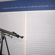 Bible verse decal above a window and beside a telescope in a stars and astrology themed boy's bedroom