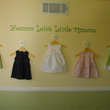 Treasure Life’s Little Moments on a wall hung with five cute little dresses in a Little Girl's Room. Life's Little Moments
