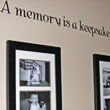 A wall quotation on the the family hallway with family photos in black color picture frames - A memory is a keepsake photo Collage.