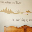 Inspirational wall decal about relationship above the bedroom headboard with design images on the wall.