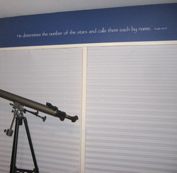 He determines the number of the stars and call them each by name, Psalm 147:4.Star Gazing in a binocular telescope on a white horizontal window blinds inside the astronomy themed bedroom.