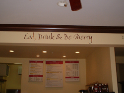 A Wall decor on the overhead beam in the cafe area - Eat, Drink & be Merry
